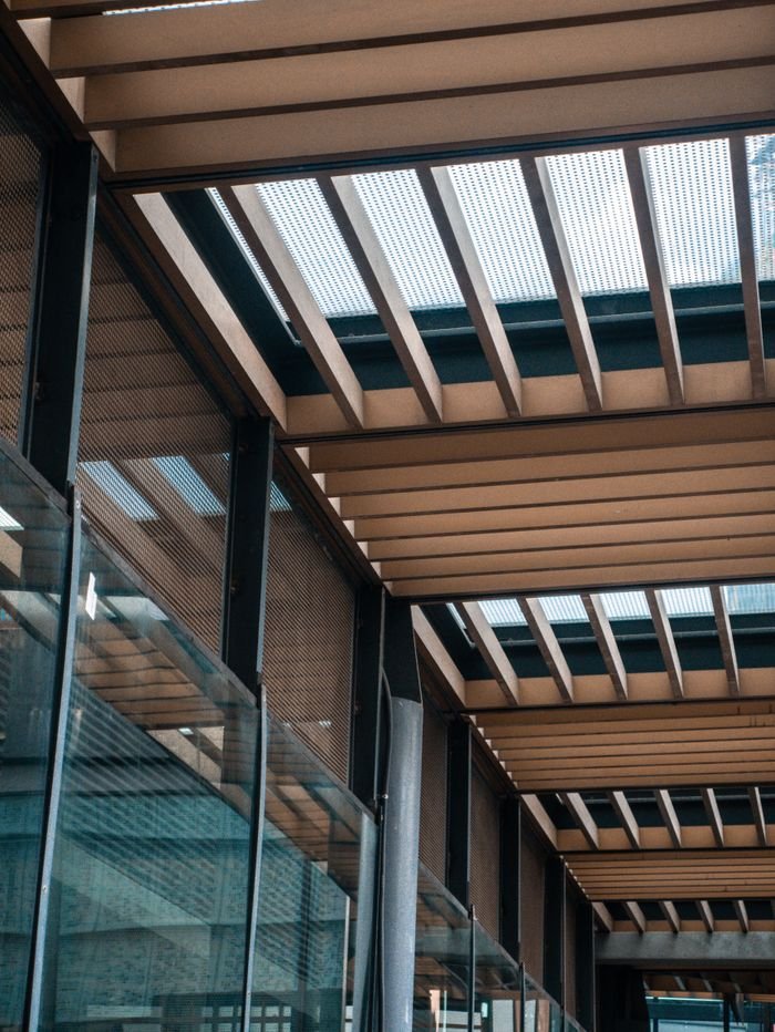 Crafting Captivating Headlines: Your awesome post title goes here A striking view of urban architecture featuring wooden beams and glass panels in a city setting.