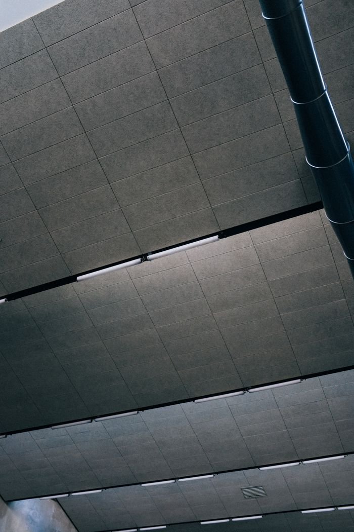 Mastering the First Impression: Your intriguing post title goes here Close-up view of industrial ceiling panels and ventilation system in a modern building.
